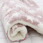 Close-up of a fluffy pink and white blanket on a white background