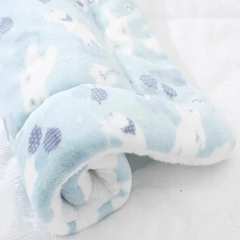 Folded baby blanket with blue and white pattern on a white background