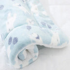 Folded baby blanket with blue and white pattern on a white background