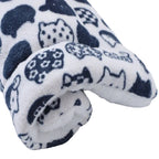 Folded fleece blanket with cat pattern on a white background