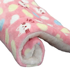 Pink fleece blanket with cartoon dog design on a white background