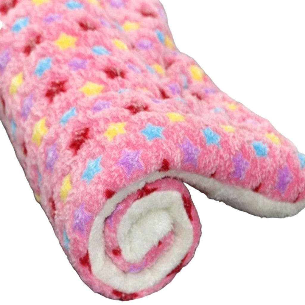 Pink textured blanket with colorful star patterns on a white background