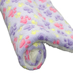 Roll of fabric with colorful paw prints on a white background