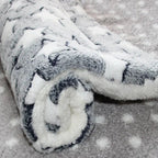 Roll of white fabric with black patterns on a textured surface