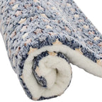 Rolled-up fleece blanket with a textured pattern on a white background