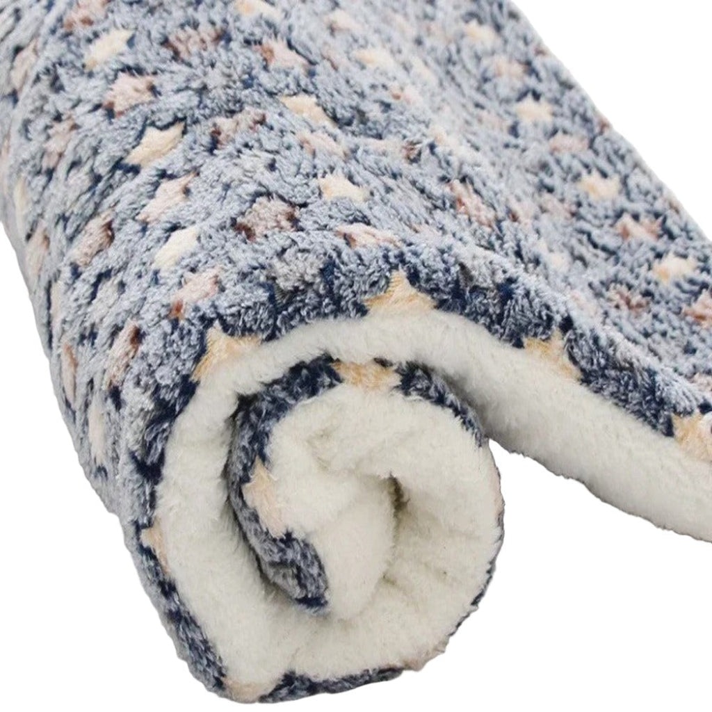 Rolled-up fleece blanket with a textured pattern on a white background