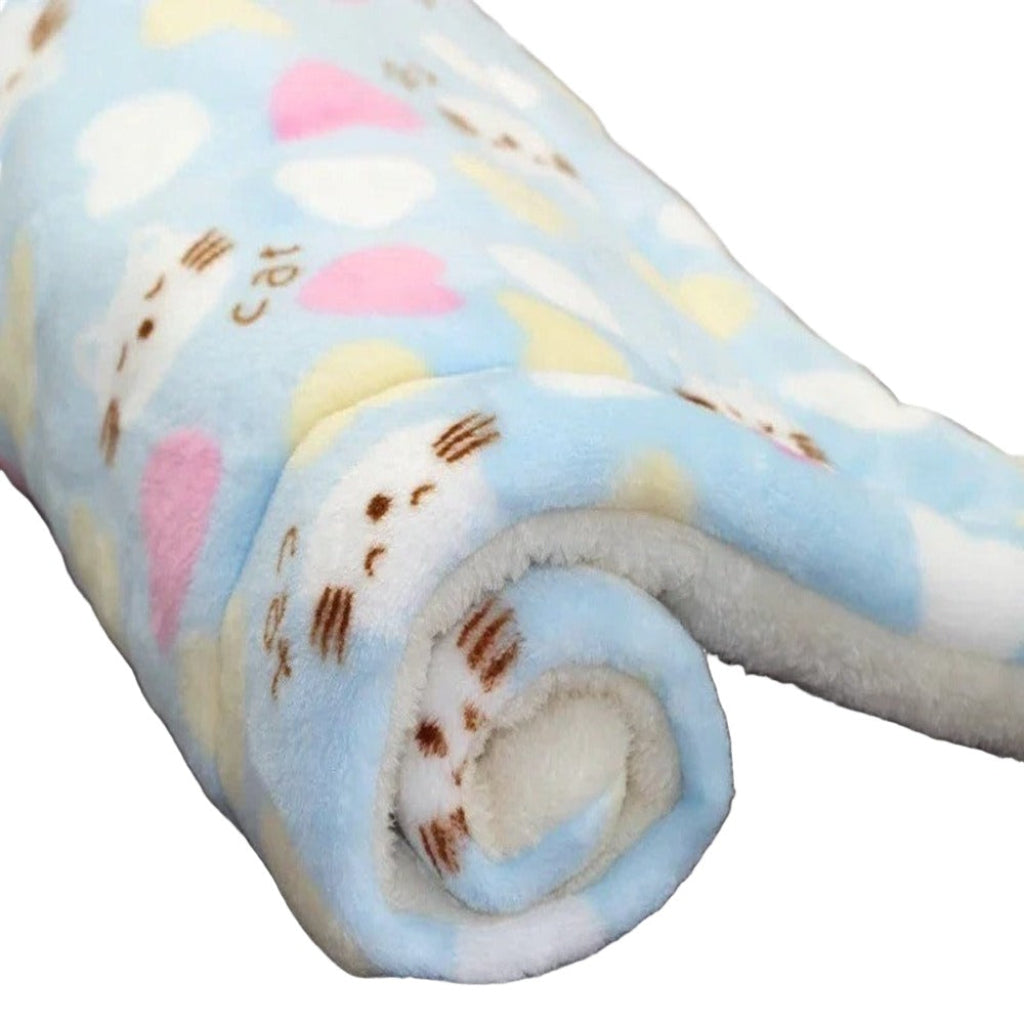 Rolled-up fleece blanket with heart patterns on a white background