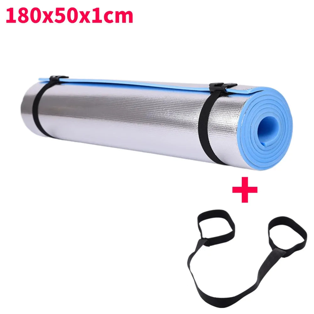 Roll of yoga mat with black straps on a white background