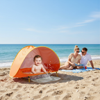 Baby in orange beach tent with pool on sandy beach