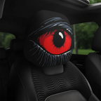 Close-up of red devil's eye car headrest cover on black leather seat