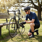Cyclist using cordless digital tire inflator on bicycle tire
