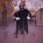 Ghost face scarecrow in full haunted yard Halloween setup with tombstones and fog