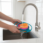 Parent washing gyro bowl at sink