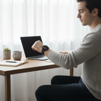 Smartwatch worn at desk checking notifications