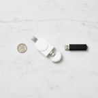 Ultra-compact Apple Watch charger size comparison with coin and USB drive