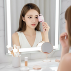 Woman using heated eyelash curler at vanity mirror